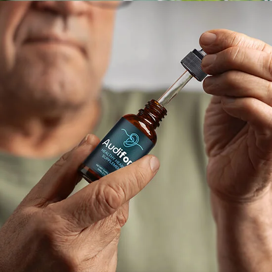 Audifort side effects: a man holding an Audifort dropper bottle with the dropper lifted